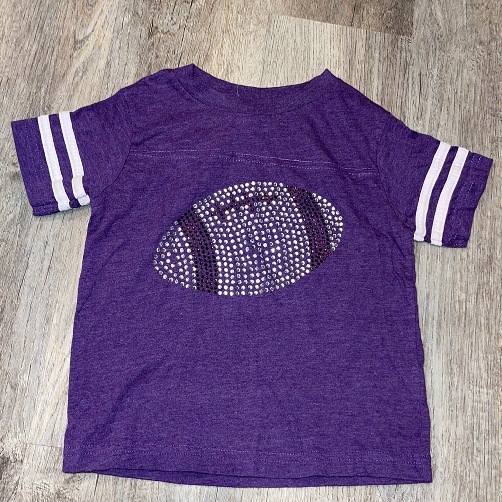 Studded purple football tee size 2. Gently used.